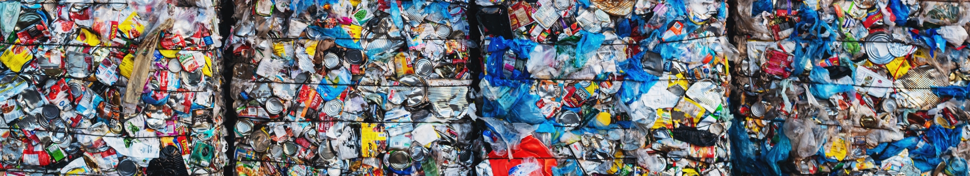 Multiple large bales of recyclables like metal cans.