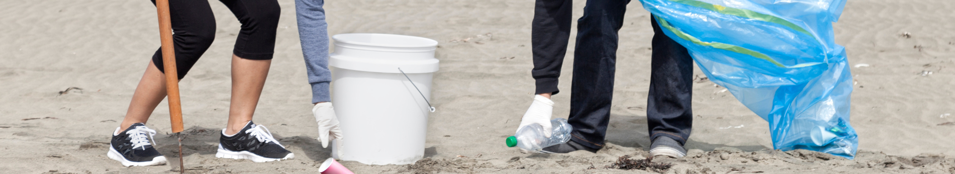 Cleanup volunteers picking up trash off the beach